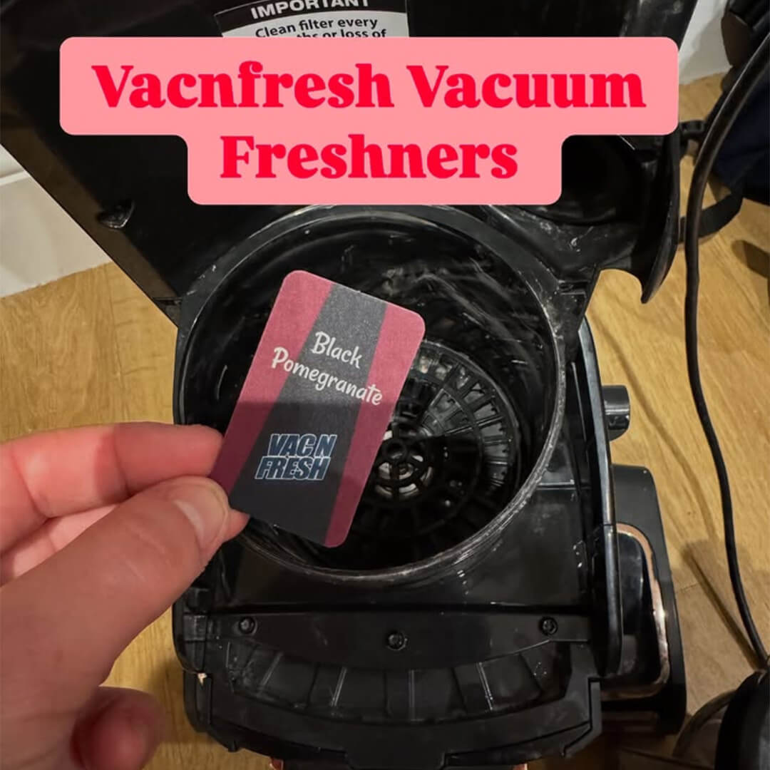 Close up shot of a Vac N Fresh Black Pomegranate vacuum air freshener being placed into a vacuum cylinder