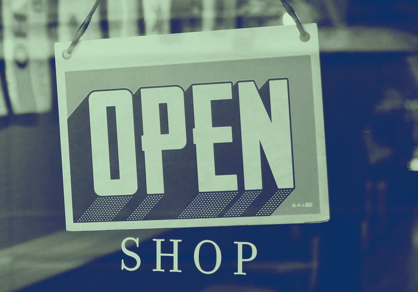 Close up of an 'Open' sign in a shop window
